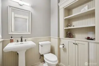 1/2 bath near the laundry complete with built ins and tile floors