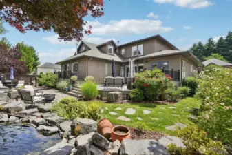 peaceful back yard with outdoor speaker, 500+ sq ft deck with multi levels and natural gas grill hook ups