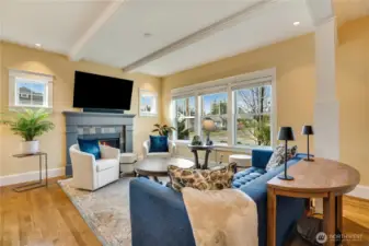 A cozy gas fireplace with a custom mantle and modern slate-tiled hearth adds inviting warmth, while a heat pump with A/C provides year-round, energy-efficient comfort.