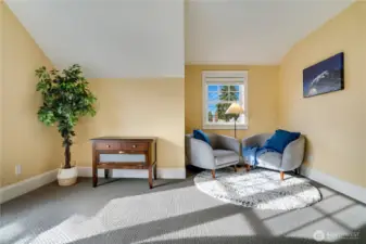 Tall ceilings and a charming nook make this room both expansive and inviting—perfect for a desk or a sun-filled reading spot.