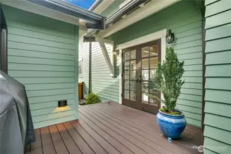 Conveniently located just beyond the detached garage, the covered French doors provide a well-lit, sheltered entry that makes coming and going effortless.