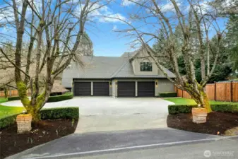 4-car garage + bay for workshop. Other side of the home has RV/boat parking space.