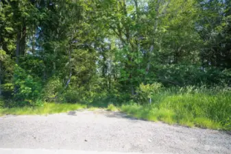 On Map - Point A.  This is property line area along the road. The Panhandle is to the left, full properrty is to the right.  The rectangular area above the "panhandle" is county owned area. Points are estmated on Pictures. Stakes are present to show points and lines.