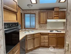 Kitchen has wall oven, plenty of counter space and tons of cabinets