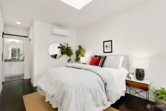 large primary bedroom with skylight