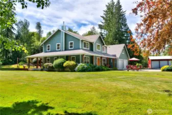 A sweeping, manicured lawn frames the home, offering an expansive green canvas perfect for outdoor play, summer barbecues, or simply soaking in the serene surroundings.