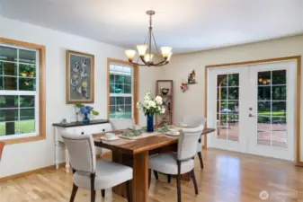 Enjoy meals in the formal separate dining room, featuring charming French doors that lead directly to the back patio—perfect for indoor-outdoor entertaining and easy access to alfresco dining.