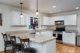 The kitchen boasts an open, airy layout filled with natural light, complemented by a dedicated eating space—ideal for casual meals and gatherings.
