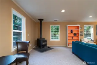 Enjoy extra warmth and rustic charm in the spacious first-floor bonus room, enhanced by a wood stove—perfect for cozy gatherings, a hobby space, or relaxing evenings.