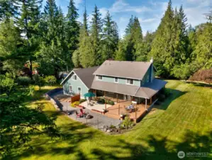 Enjoy picturesque views of the spacious backyard and entertaining areas, featuring a wrap-around porch that provides ample room for relaxing, socializing, and taking in the serene surroundings.