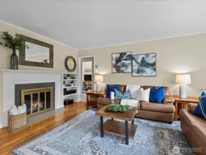 Spacious living room with wood-burning fireplace and so much natural light