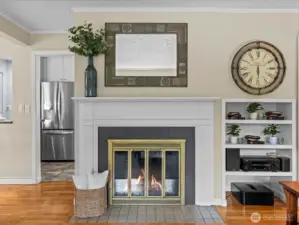 Wood-burning fireplace with gorgeous mantle and built in storage