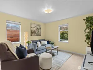 Bedroom #1 is spacious with a lot of natural light; can be repurposed as a TV or game room as shown.