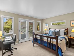Primary bedroom with gorgeous French doors that lead out onto the back deck.