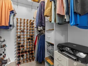 Primary walk-in closet with a lot of storage space