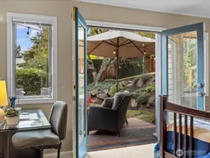 Primary Bedroom featuring French doors out to back deck. Can you imagine stepping out for your first cup of coffee in the morning? So inviting and private.