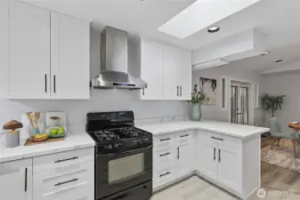 Skylight floods the kitchen with natural light while open flow connects you to dining and deck access.