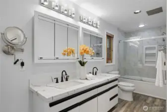 The main bathroom features dual sinks, providing ample space and enhancing morning routines.