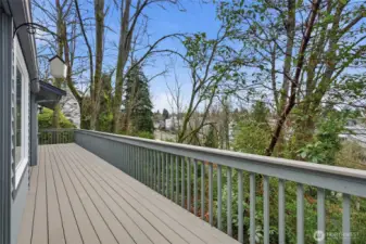 This deck runs the entire front of the house with doors from both the living room and primary bedroom. Treetop views from either entry point.