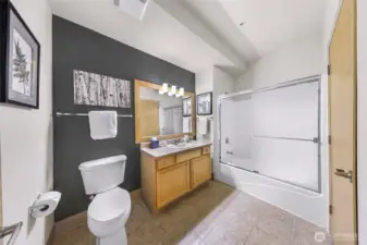 This bathroom has a full bathtub and shower.