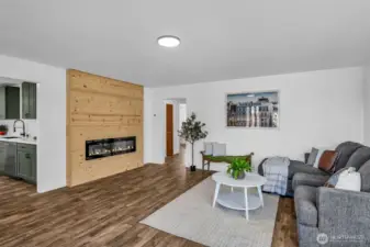 To the left is the entry to the kitchen or travel through the hall to three bedrooms and a hallway bathroom