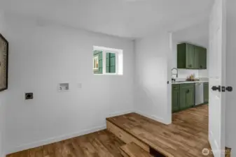 Laundry room off the kitchen with a door to the garage as well