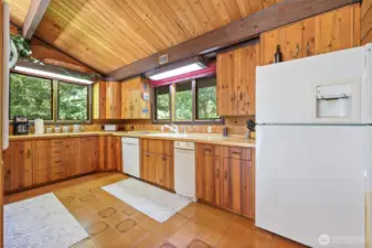 Kitchen with tile floors and dishwasher and trash compactor