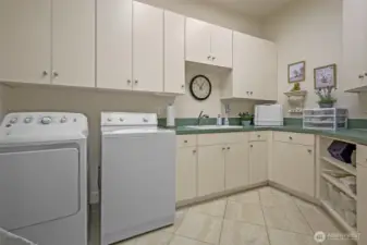 Large laundry room with cabinets and sink