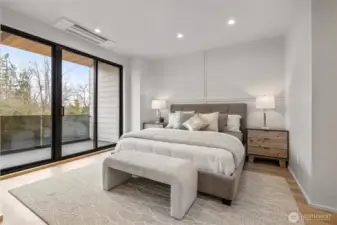The large primary bedroom features a sliding door that opens to a private deck, offering a personal outdoor escape.