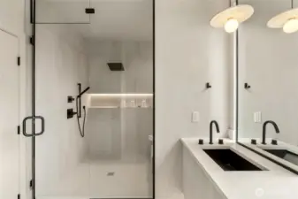 Luxurious Shower Experience: Enjoy the spacious walk-in shower featuring both a rain shower and handheld, complemented by a large illuminated niche for added convenience.