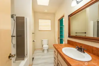Guest bath attached to second bedroom and accessible from hallway.