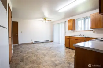 ~ Unit 703: Kitchen w/New Vinyl Floor * Kitchen Dining Area * Ceiling Fan * Slider to Back Patio & Fully Fenced Large Backyard