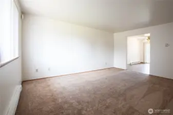 ~ Unit 703:  Opposite View of Living Area w/Entry Way to Dining Area and Kitchen