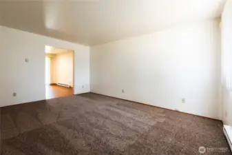 ~ Unit 705:  Opposite View of Living Area w/Entry Way to Kitchen & Kitchen Dining