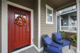 Covered porch with room for your warm welcome; inviting door with window brings in light and offers keypad for convenient security.