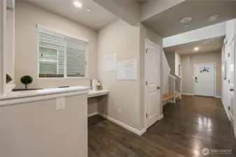 Wide and bright entry hallway leads to coat closet, garage on right, 1/2 bath near the front door, and stairway to second level...