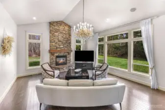 Living room with large picture windows overlooking the yard