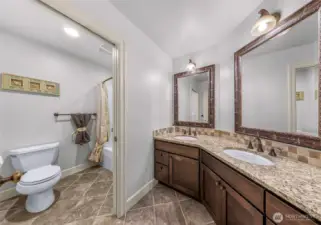 Bathroom with extended vanity and storage with shower/tub in pocket door toilet room