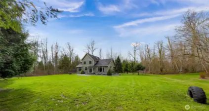 Expansive yard and lawn area surrounding the home