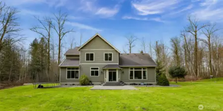 Rear exterior of the home and backyard