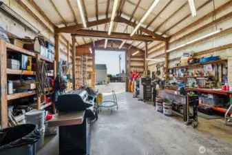 Insulated detached shop- concrete floors, insulated walls, plenty of light & storage racks.