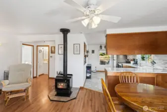 Steps inside the front door you are greeted by the warm & cozy woodburning fireplace which opens up the kitchen, dining & family room.