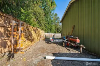 Plenty of wood storage + RV or boat parking on side & behind the detached shop.
