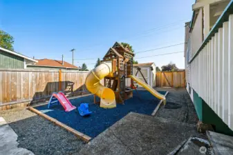 Playground area on side of the house with rubber chips to make playing easy on the kids.