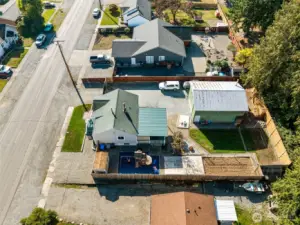 From above, you can see the full scope of this property’s features—plenty of parking in front, extra street parking, and easy access through the double gate to the spacious detached shop.
