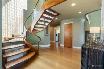 Note the custom, one-of-a kind staircase built out of wood and glass.