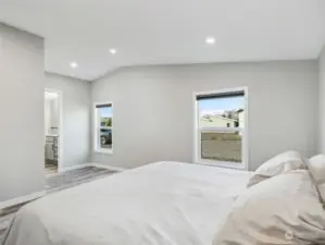 Primary bedroom features vaulted ceilings and abundance of natural light.