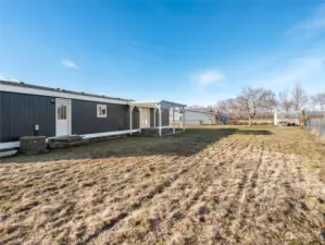 Large level backyard with small storage shed.