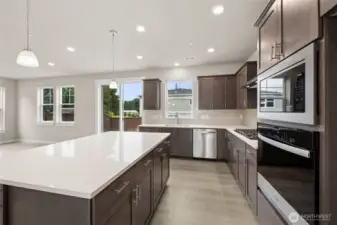 Gas cooktop, quartz countertops, gourmet hood vent, dishwasher, pendent lighting, soft close cabinets, built-in oven and microwave all included.