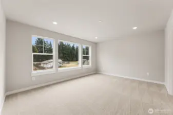 Large primary bedroom can hold a King size mattress and more. Features very large windows for natural light. Photo contains virtual staging.
